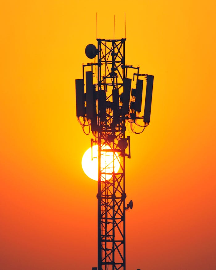 Mastering the First Impression: Your intriguing post title goes here A striking silhouette of a cell tower set against a vibrant sunset sky, highlighting technology and nature's beauty.
