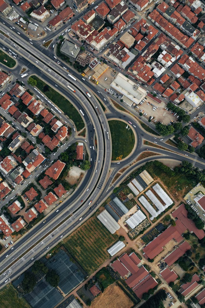 A detailed aerial photograph showcasing a city's highway and suburban housing layout, ideal for urban planning themes.